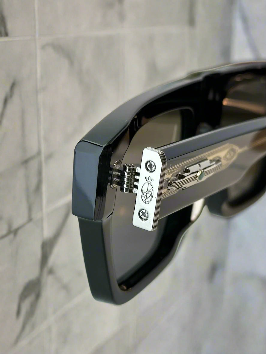 Close-up of a car door handle with a visible brand logo on a white car background