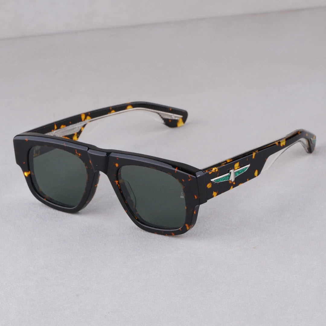 A pair of square-shaped, thick solid acetate sunglasses with a patterned frame and green mirrored lenses.