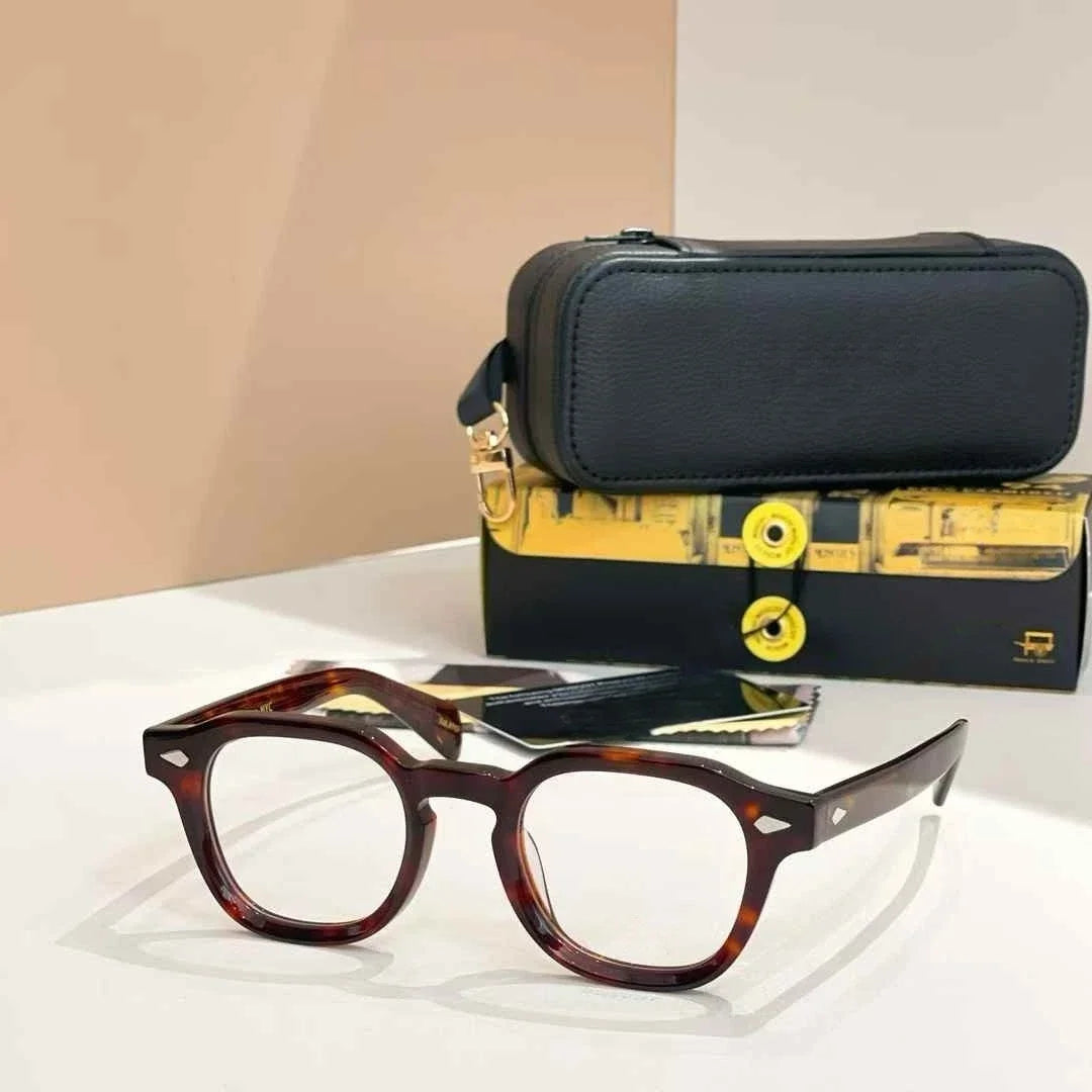 Tortoiseshell glasses with a black carrying case on a white surface