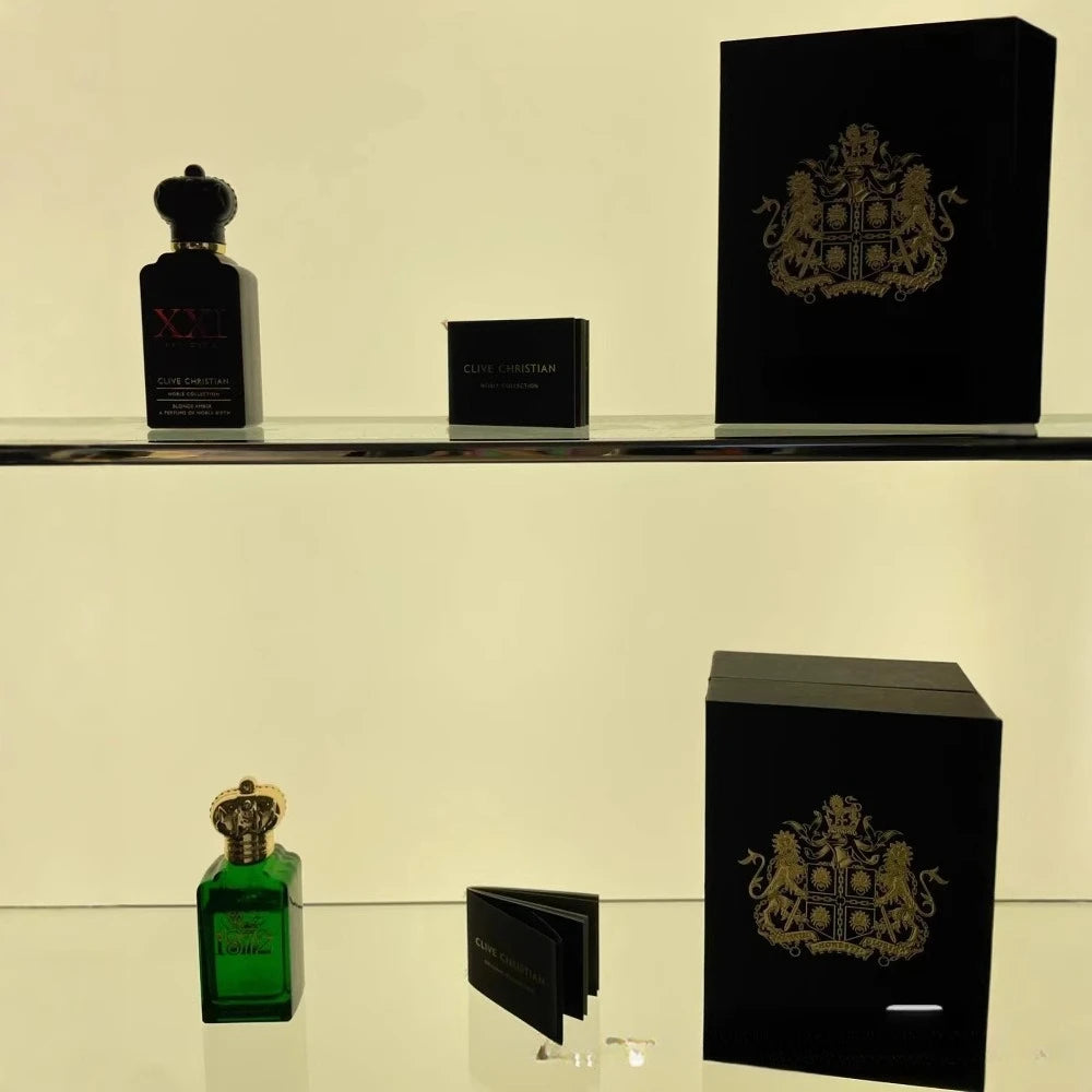 Two perfume bottles and their packaging on a shelf with a beige background