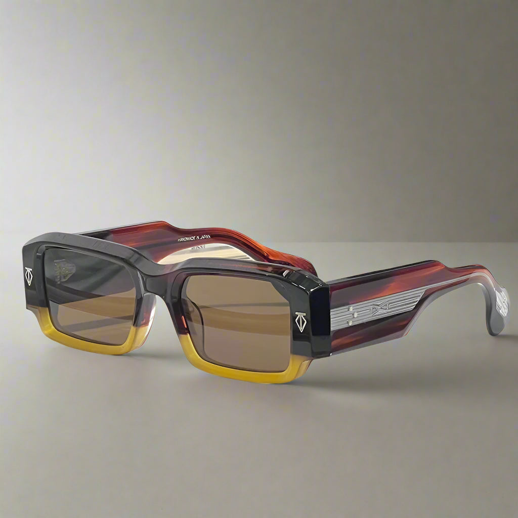 Sunglasses with a tortoiseshell frame and brown lenses on a white surface.