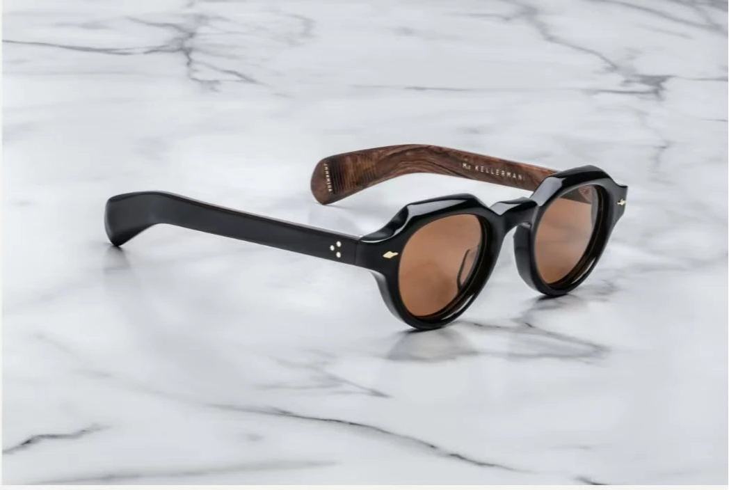 Sunglasses with wooden arm on a marble background, featuring the Kellerman brand.