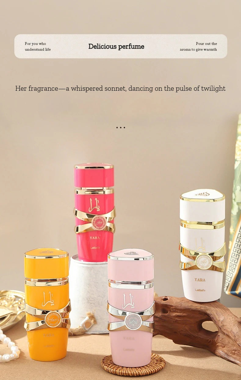 Collection of perfume bottles with decorative packaging on a wooden surface.