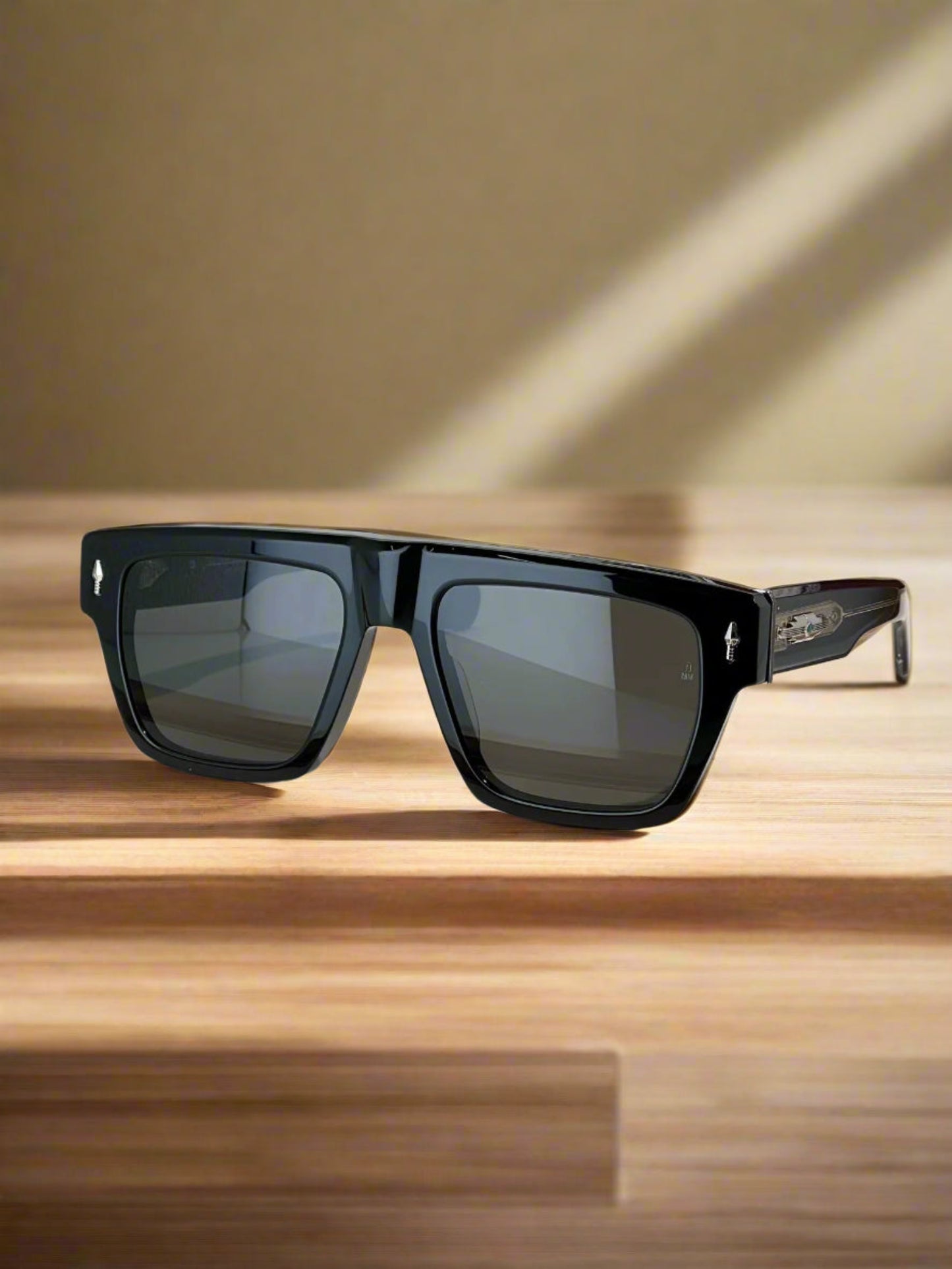 Black sunglasses on a wooden stand with a maroon case in the background