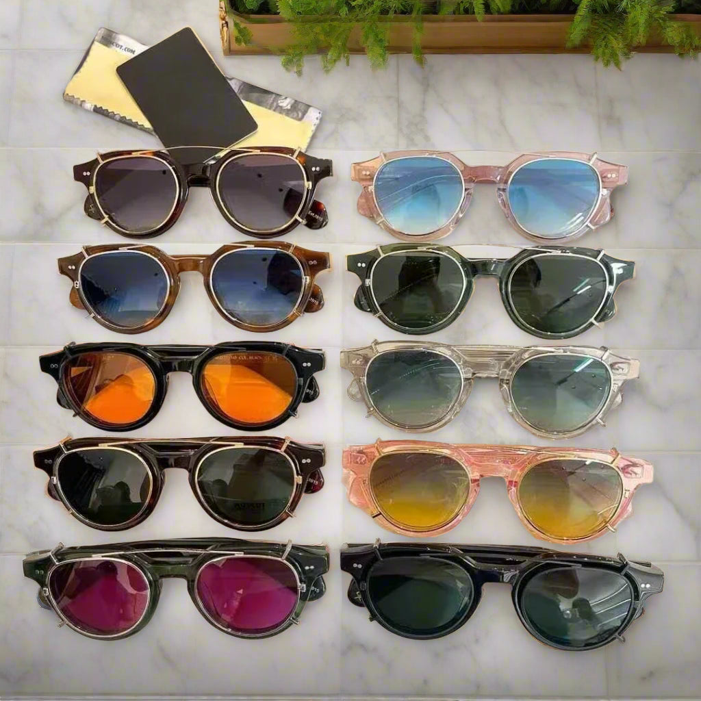 Collection of various sunglasses on a white surface moscot