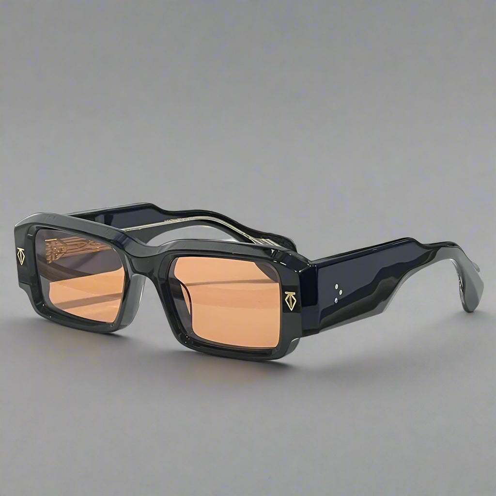 Black sunglasses with brown lenses on a white surface with a gray background