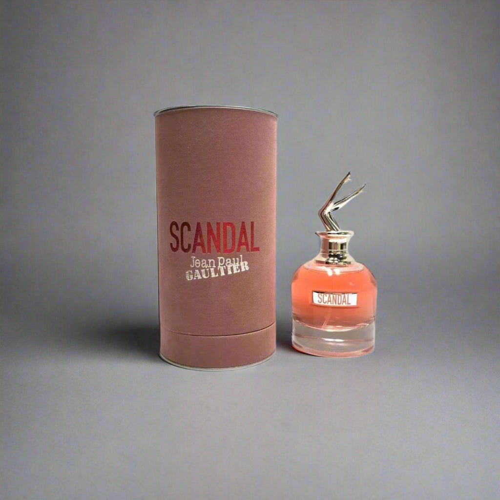 Scandal perfume bottle and cylindrical container on a white background