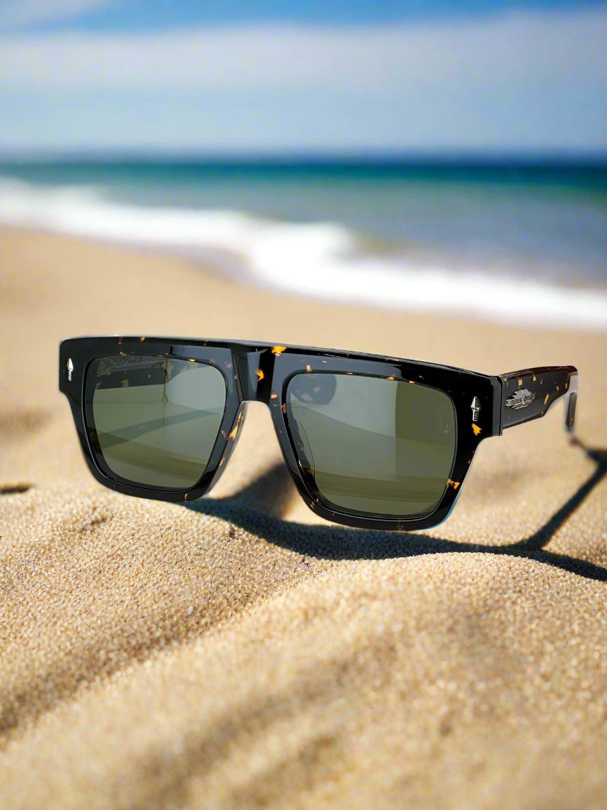 Sunglasses with a brand box on a reflective surface