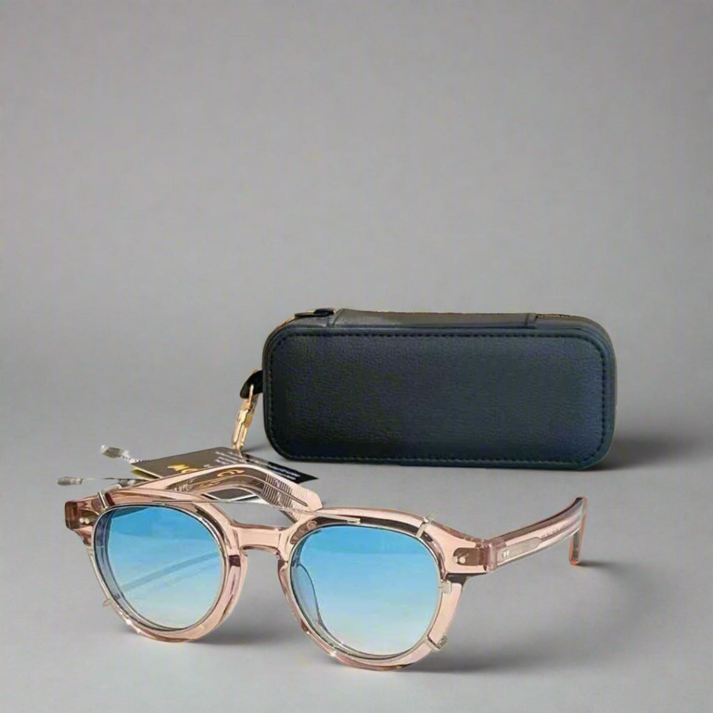 Sunglasses with blue gradient lenses and a black case on a reflective surface.