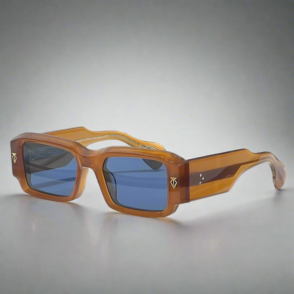 Wooden sunglasses with blue lenses on a white surface with a textured gray background