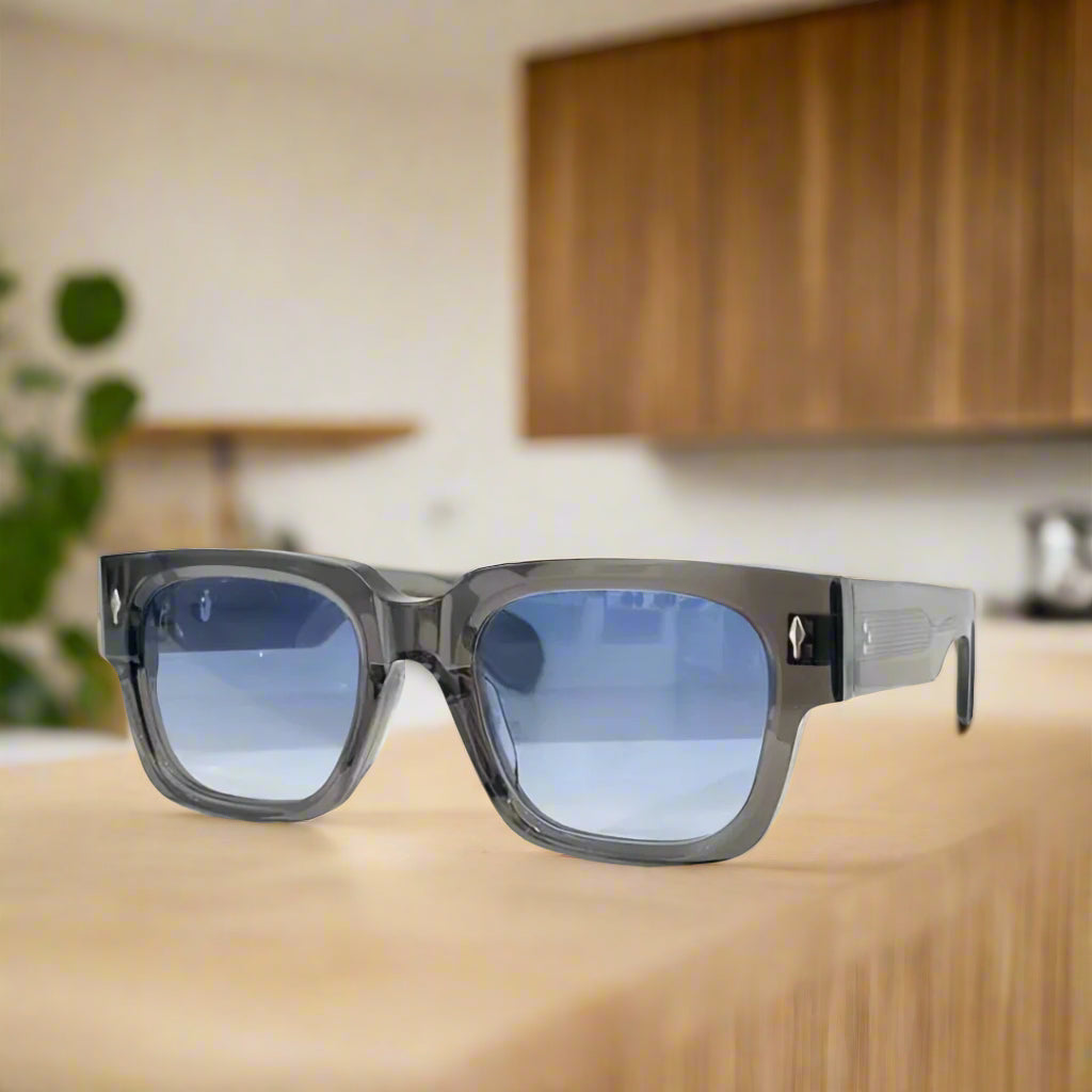 Sunglasses with blue gradient lenses on a white surface