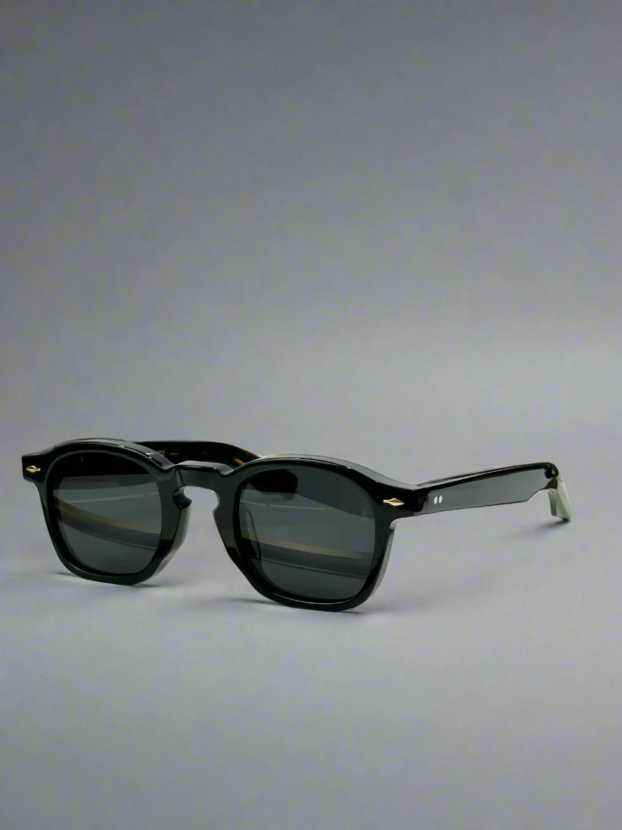 Black sunglasses on a wooden stand with a ZEPHIRIN branded box in the background.