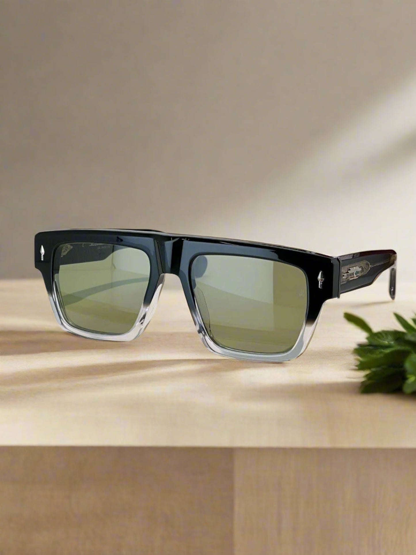 Sunglasses on a display stand with a branded case in the background