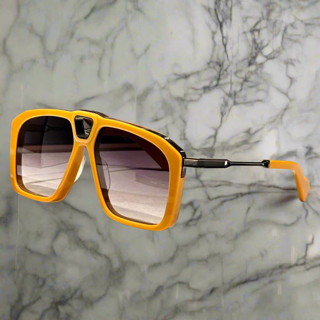 Yellow sunglasses on a wooden surface with a blurred background