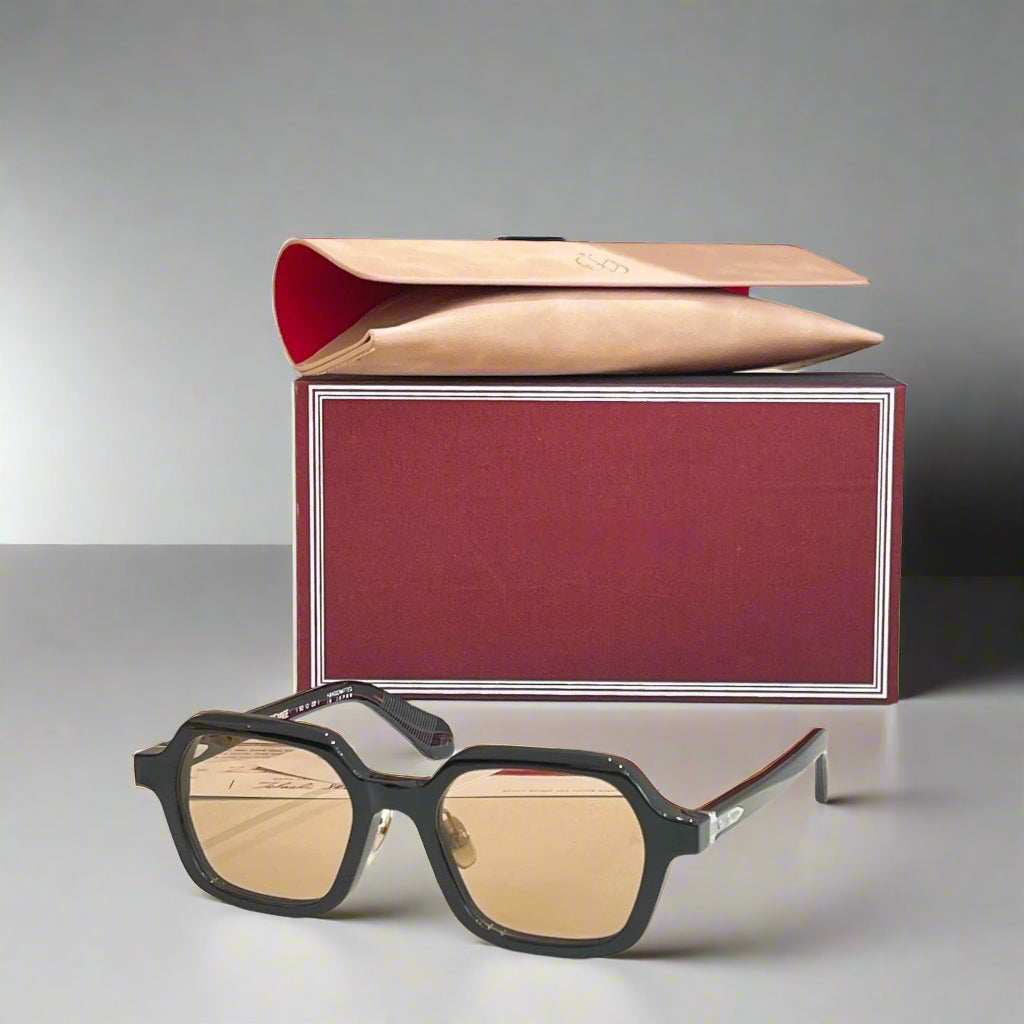 Sunglasses with a red box on a light surface