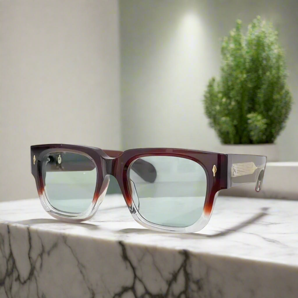 Sunglasses with tortoiseshell frame and light blue lenses on a white background