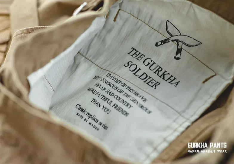 Close-up of beige pants with brand label on a blurred background
