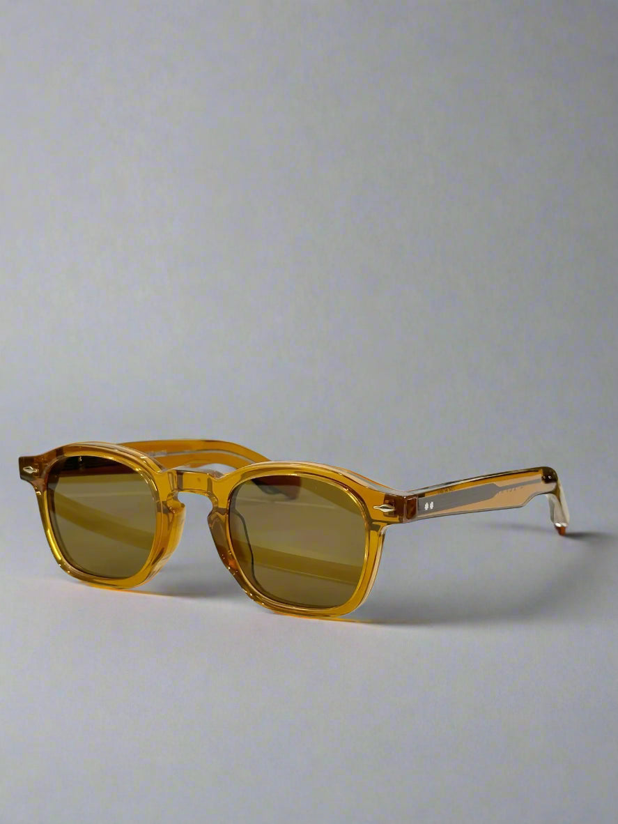 Brown sunglasses on a gold stand with a green box in the background