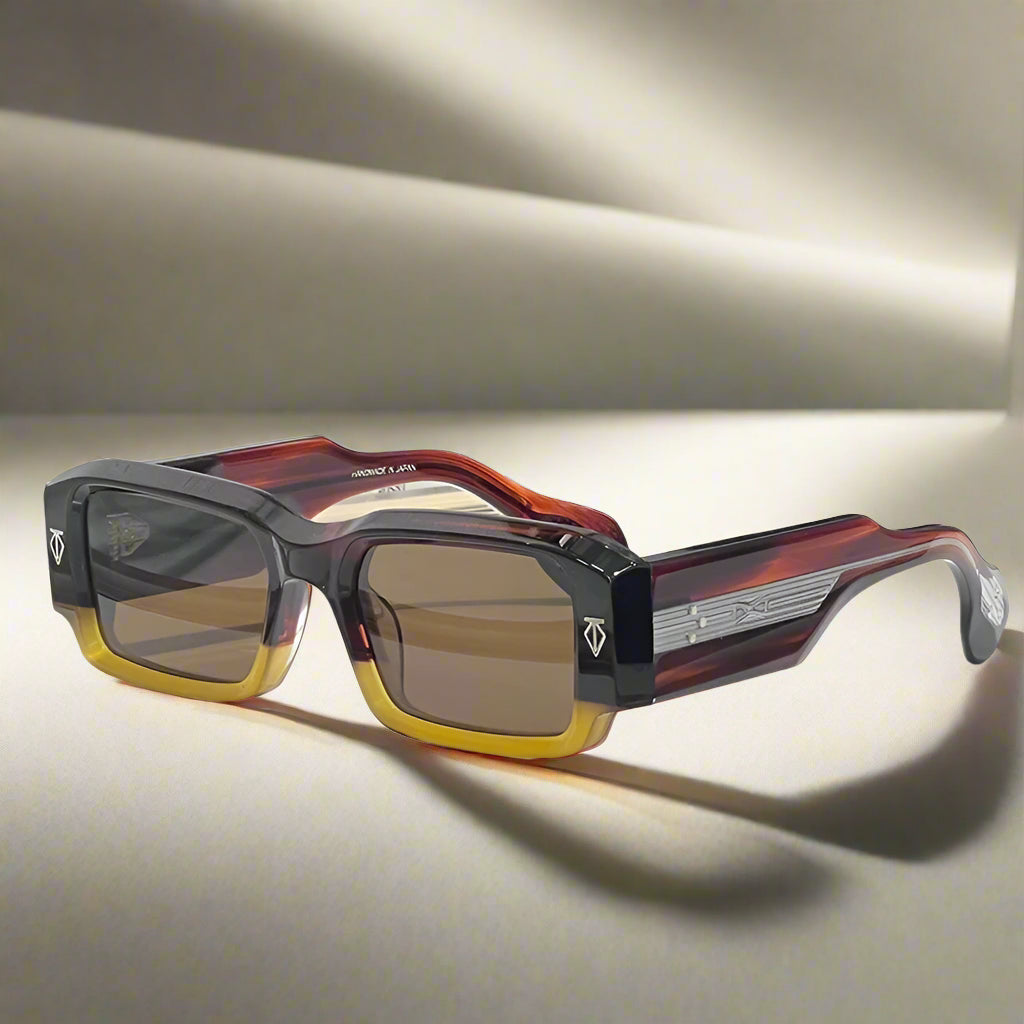 Sunglasses with a tortoiseshell frame and brown lenses on a white surface.