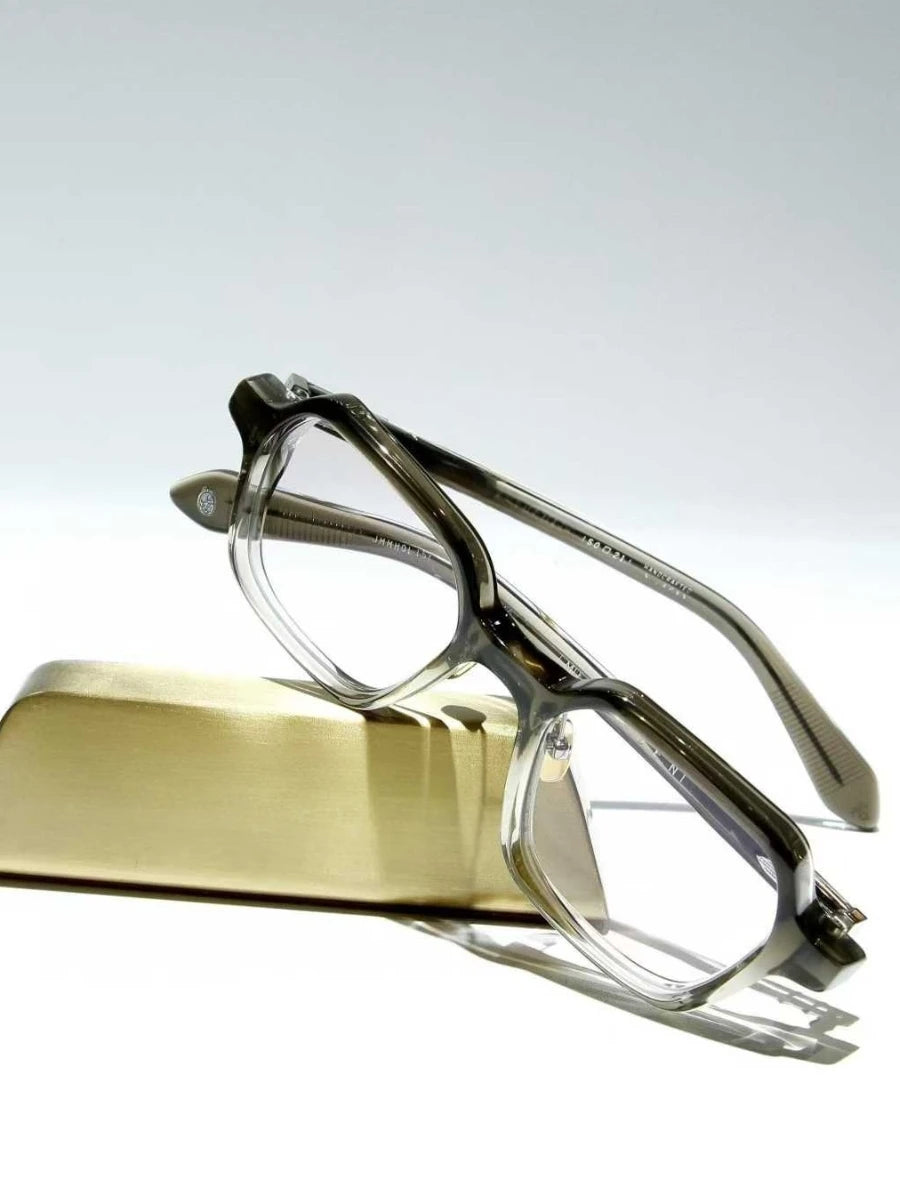 Eyeglasses on a gold stand against a white background