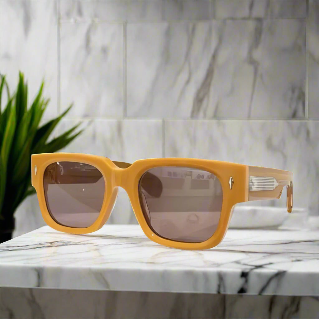 Yellow sunglasses with brown lenses on a white background