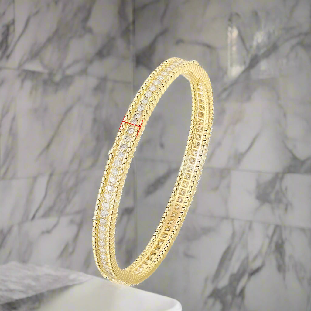 Gold bracelet with moissanite stones on a white background