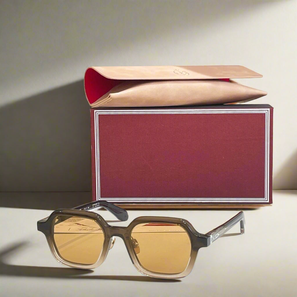 Sunglasses with a red box on a white surface
