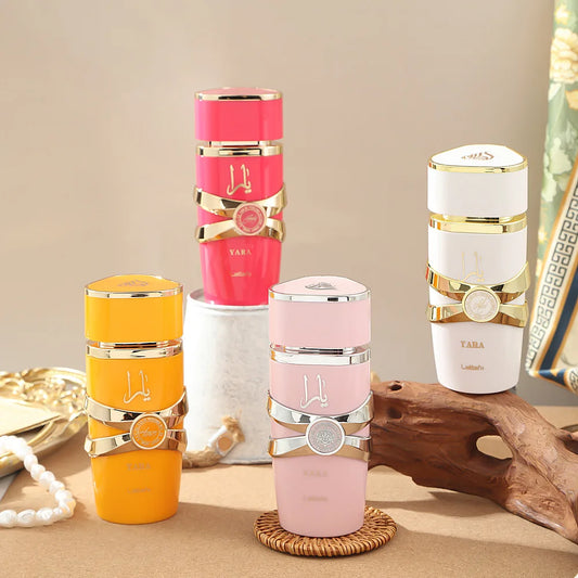Set of colorful skincare bottles with gold accents on a neutral background