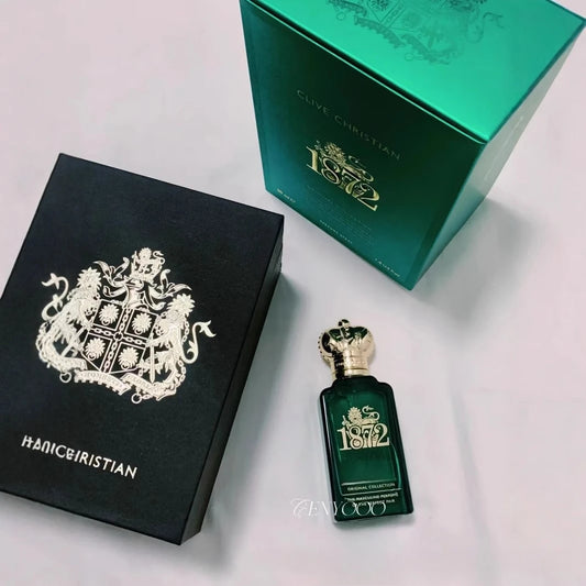 Green perfume bottle and packaging with '1872' branding on a light gray background